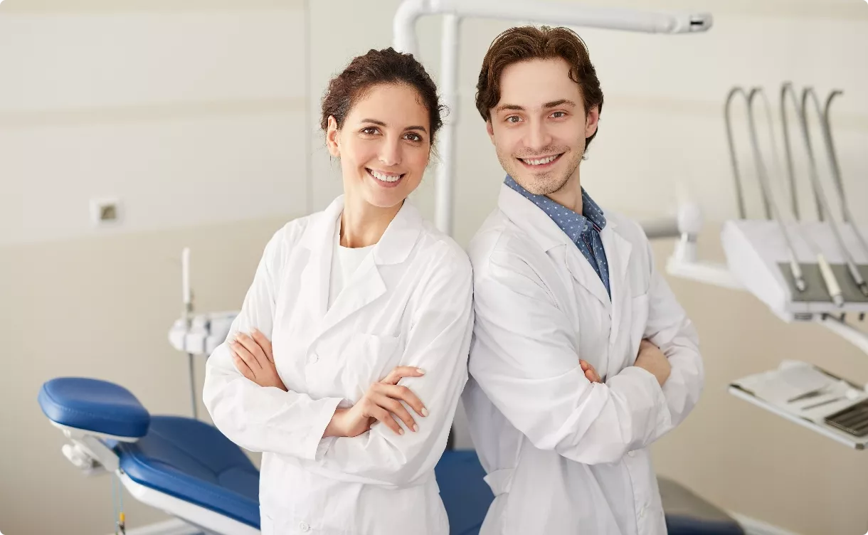 two techs smiling in exam room