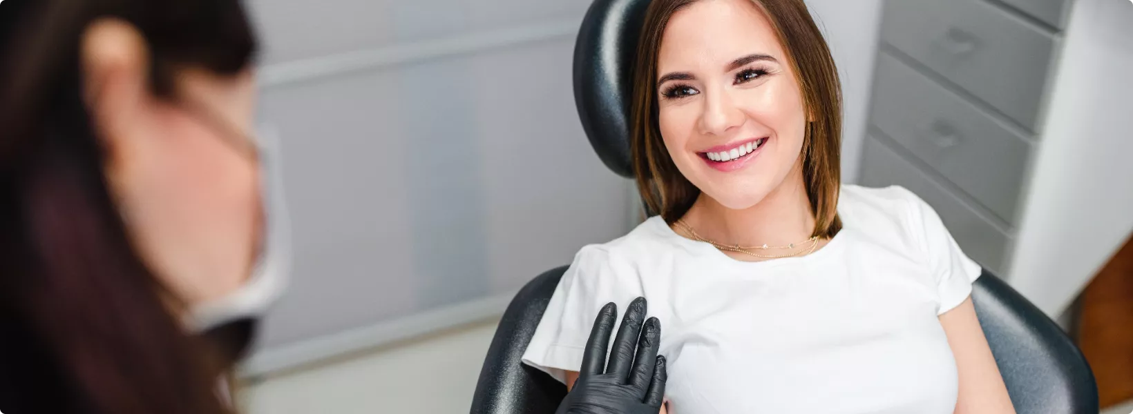 assured patient smiles in chair